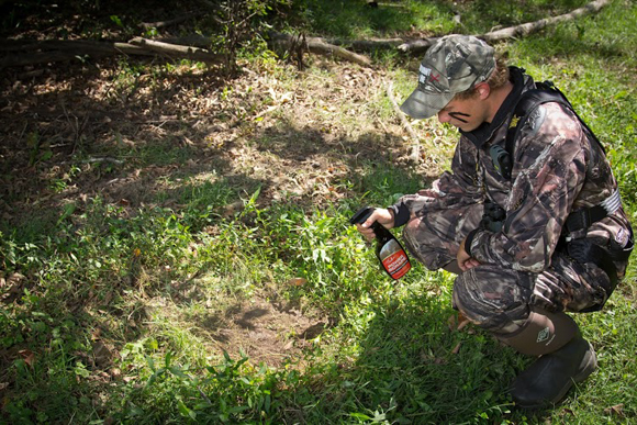 A hunter sprays one of Tinks products to attract animal with scent