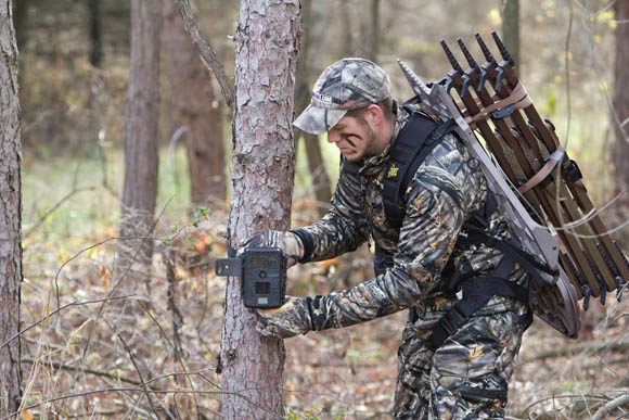 Man setting up trail camera