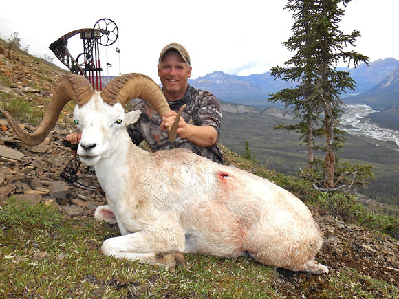 Hunter with killed Ram next to him