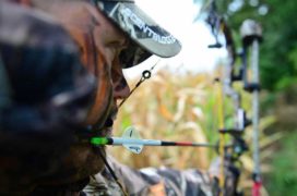 Bowhunter looking threw peep sight.