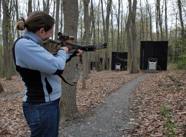 Woman shooting a crossbow