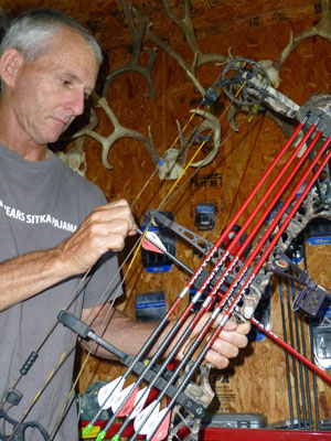 Hunter working on bow with Maxima RED arrows