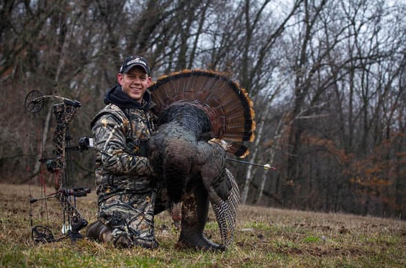A hunter with an Arrowed Turkey