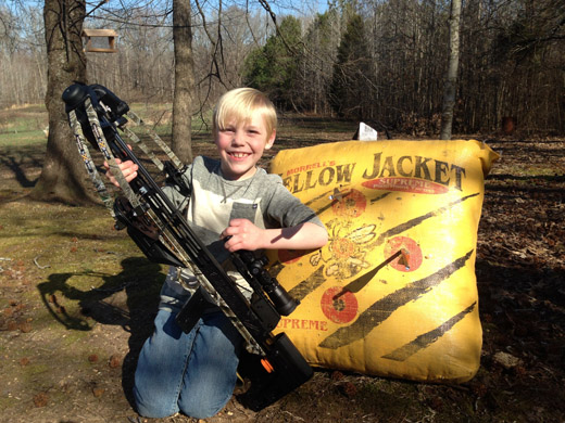 A younger boy with a crossbow