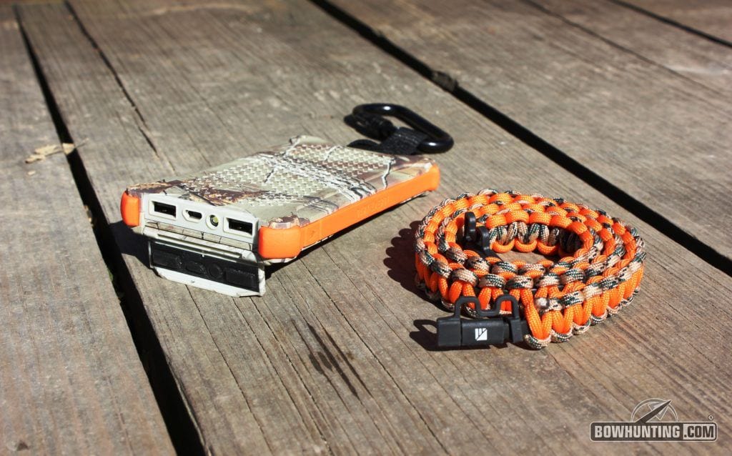 Picture of waterproof flap opened, 2.4amp, 1.0amp, micro usb, and flashlight along with usb / micro usb charging cord. 