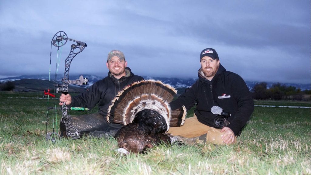 bowhunters with dead turkey