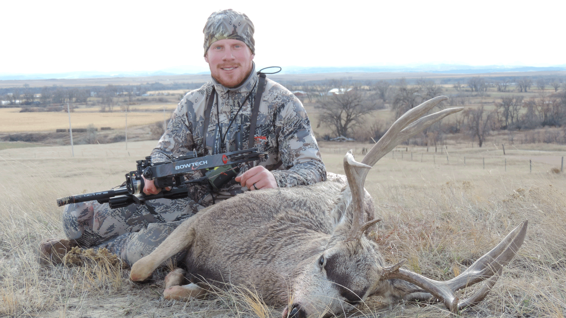 hunter with dead mule deer