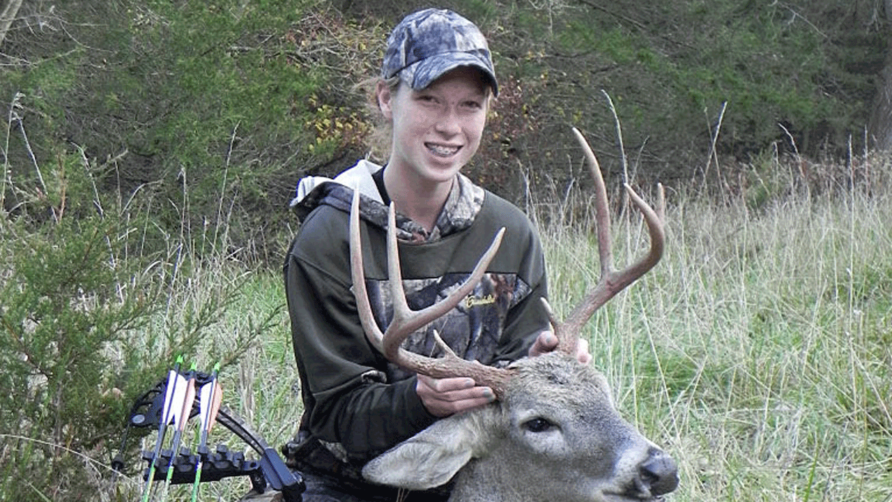young hunter with buck