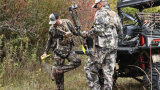 Hunters spraying down with Scent-A-Way before going bowhunting for deer.