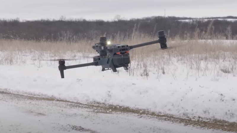 drone hovering above ground with snow landscape