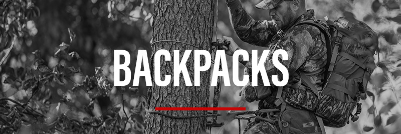 Bowhunter climbing tree wearing large backpack