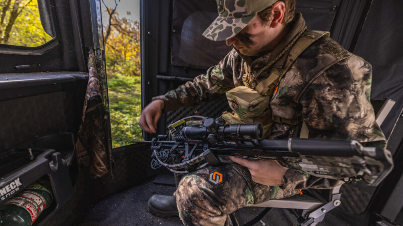 crossbow hunter in redneck blind
