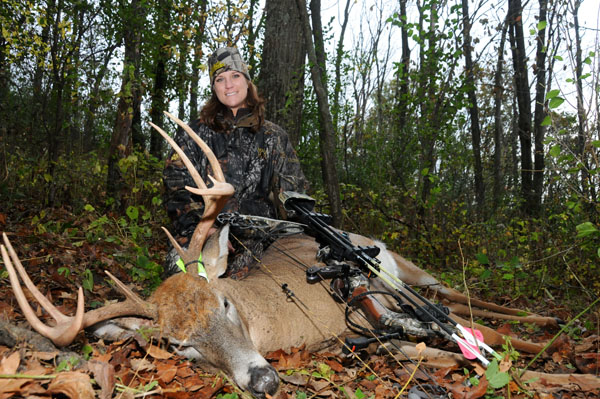 Woman hunter with buck