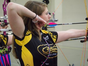 Sarah Lance shooting a bow